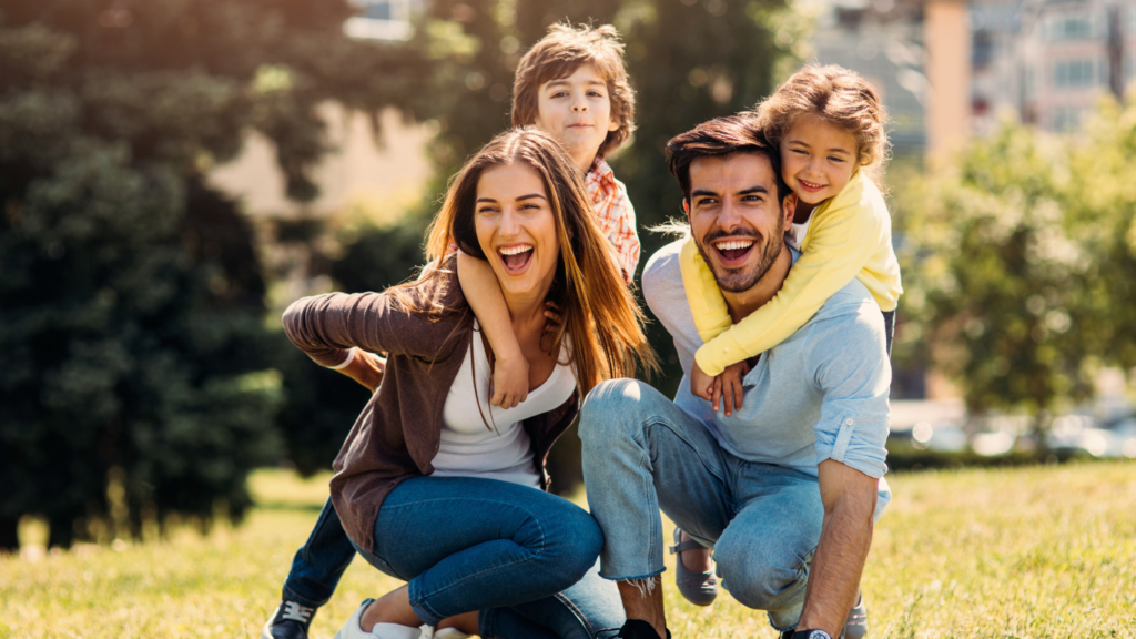 Family playing in a field on a sunny day