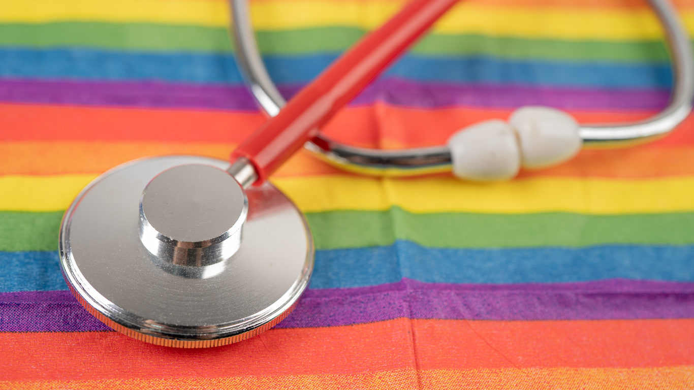 Stethoscope laid on a LGBTQ+ Pride flag